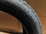 a close up of a tire on the floor next to a cardboard box