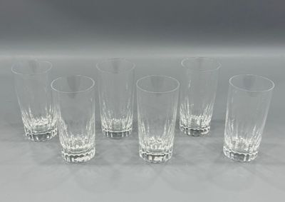 six glasses are lined up in a row on a white surface
