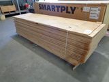 a large stack of wood sitting on the floor in a warehouse