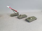 four toy tanks with a missile on top of them