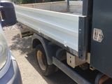an image of a truck with a flat bed in a parking lot