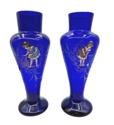 two blue vases with a picture of a woman and a dog on them