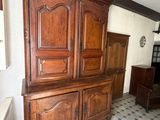 a large wooden cabinet in the corner of a room