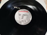vinyl record with a picture of a man ' s face on the side of it
