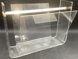 a clear plastic magazine holder on a black surface