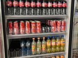 a refrigerator filled with drinks and sodas in a store