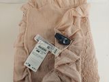 a pink blanket with a cell phone on top of it