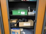 a cupboard with many boxes and other items in it