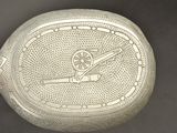 an image of a silver plate with a design on it