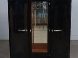 a black cabinet with a mirror on top of it
