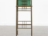 a green cabinet with a shelf on top of it next to a white wall