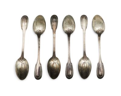 six spoons are lined up in a row on a white surface