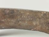 a close up of a knife on a white surface