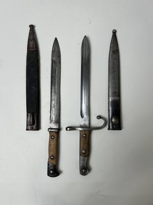 three knives are sitting on a white surface next to each other