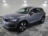 un SUV Volvo gris garé dans une grande pièce au sol carrelé