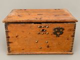 an old wooden box with a metal latch on the lid