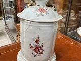 a white container with a bird on it on a table