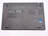 the bottom of a laptop with a blue sticker on it