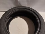 a close up of a tire on a white surface