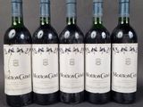 four bottles of wine are lined up in a row