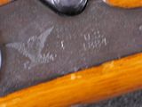 a close up of a pair of scissors on a piece of wood
