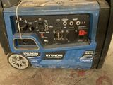 a blue and black generator that is sitting on the ground