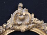 a gold frame with a picture of a bird on it