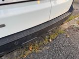 a white car parked on the side of the road