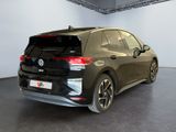 the rear end of a black volkswagen e - golf in a showroom