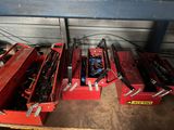 two red tool boxes with tools in them sitting in a garage