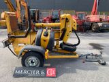 a small yellow machine that is parked in the parking lot