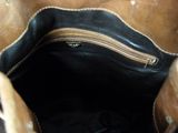 a brown bag with a zipper on it sitting on a table