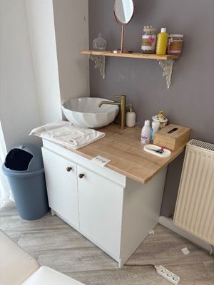 a bathroom with a sink and a radiator in it