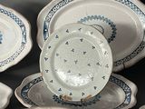 many plates and bowls that are sitting on a table