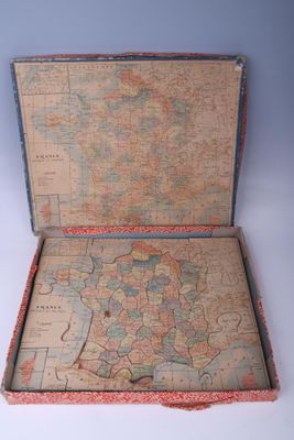 une valise contenant une carte, posée sur une surface blanche