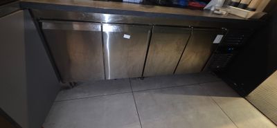 a stainless steel dishwasher in the corner of a kitchen