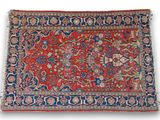 a red and blue rug with floral design on a white background