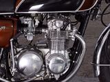 a brown and black motorcycle parked in a garage