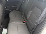 the back seats of a white car with a black seat belt