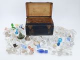 a small chest full of glass bottles and a pair of scissors