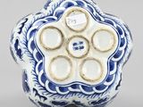 a blue and white vase with a flower design on it