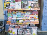 a display of magazines on a cart outside of a building
