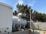 a large tank sitting on top of a cement wall