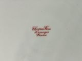 a close up of a white plate with red writing on it