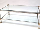 a glass coffee table with a metal base and a glass top