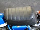 a blue motorcycle with a black seat and a black seat