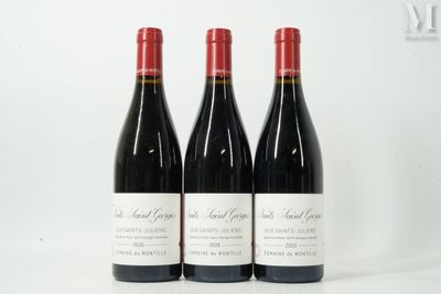 three bottles of red wine sitting on top of a white table