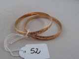 two gold rings with a price tag attached to them