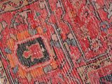 a close up of a red and blue rug with a black border