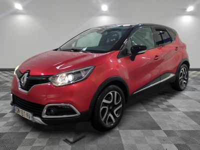 a red car parked on a checkered floor in a garage